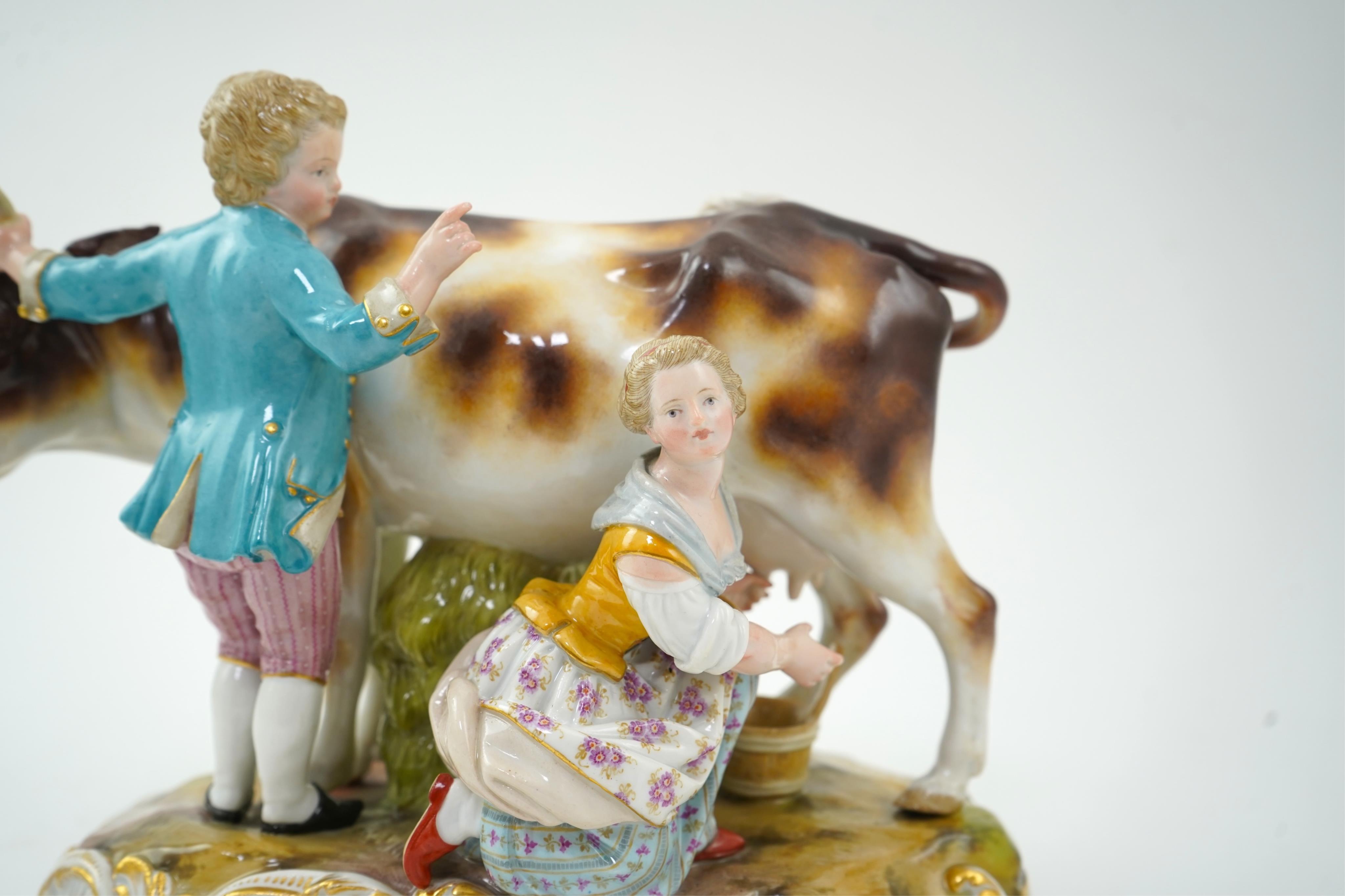 A Meissen group of a boy and girl milking a cow, 19th century